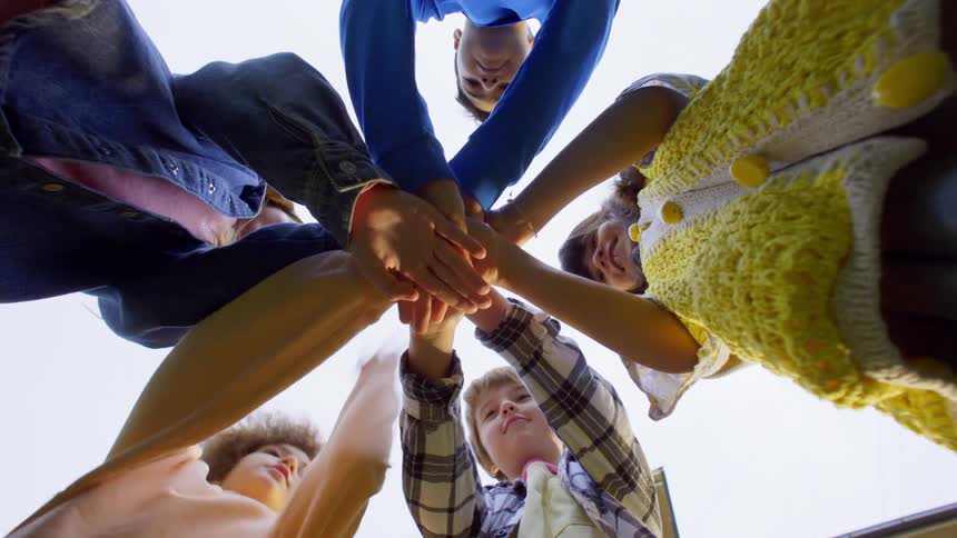 Children holding hands together outdoors