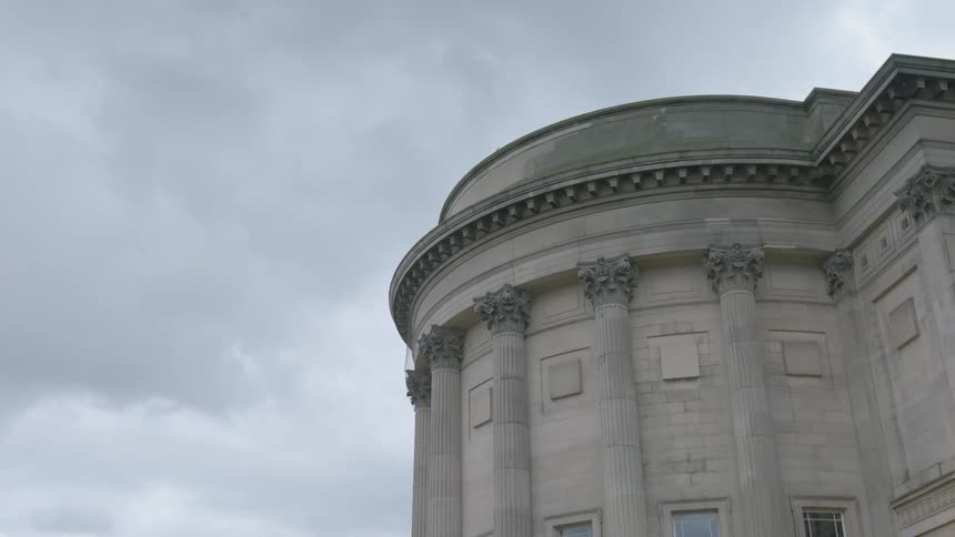 An circular building on a cloudy day