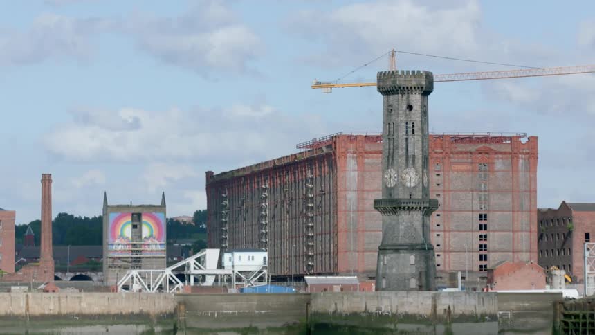 A crane sits atop an under construction building