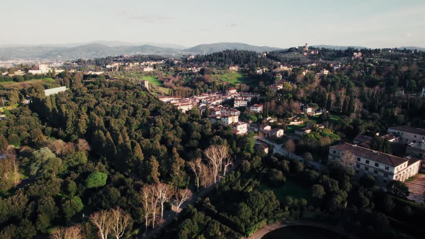 Urban city between hills and wooded mountains
