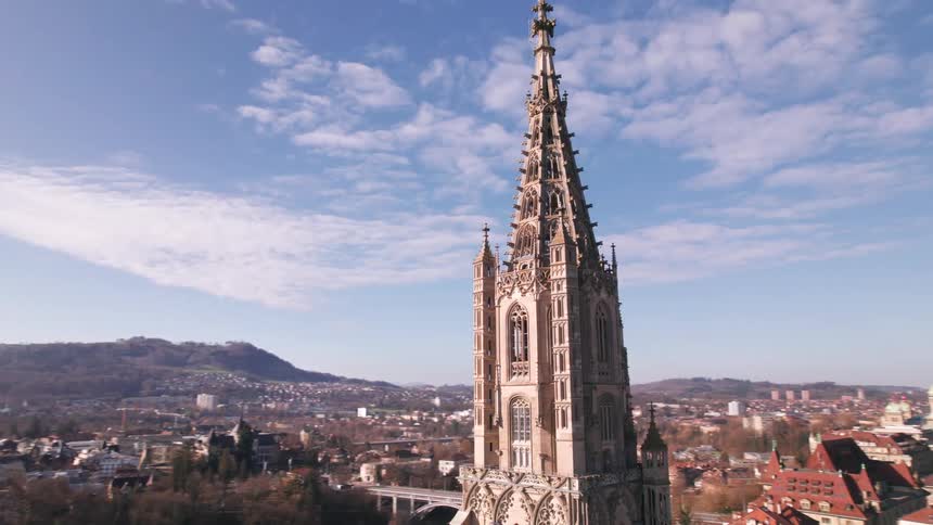 A tall steeple is in the village