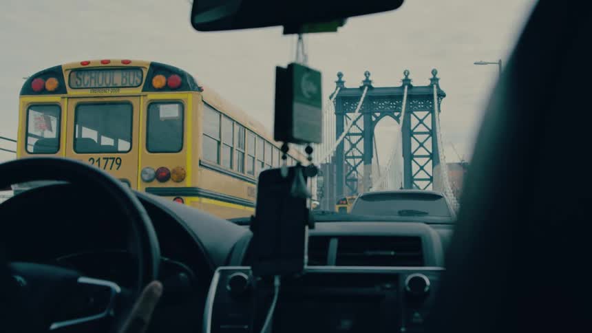 Vehicle and a school bus crossing a bridge