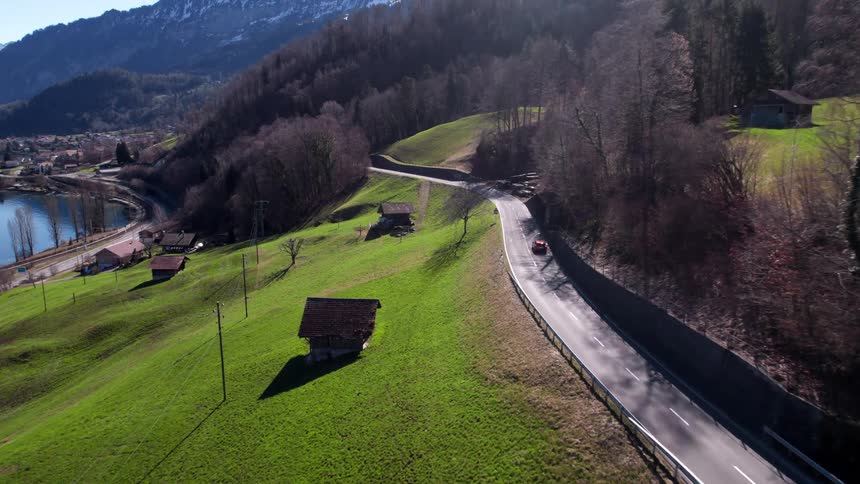 Aerial view of a narrow street leading to a picturesque lakeside village