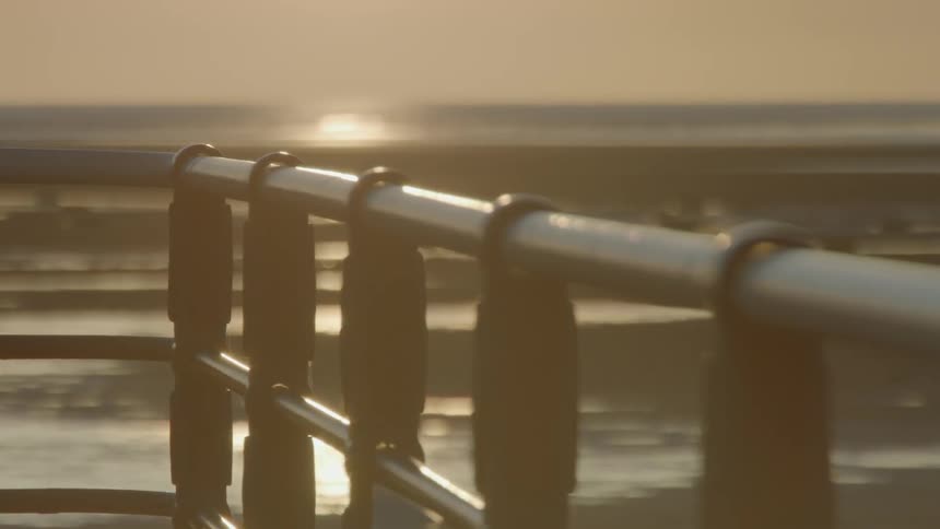A fence railing overlooking the ocean