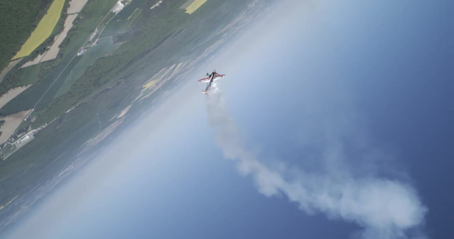 A biplane does tricks in the air