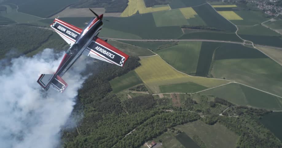 Small plane flying over a forested area