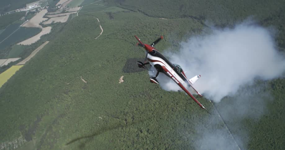 A plane flies straight up as smoke trails the plane