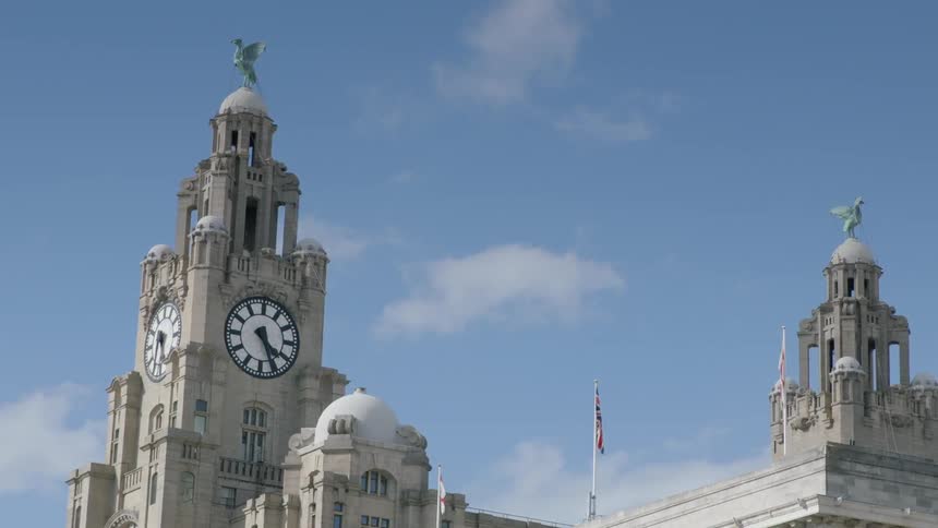 A tall tower has a clock on the side