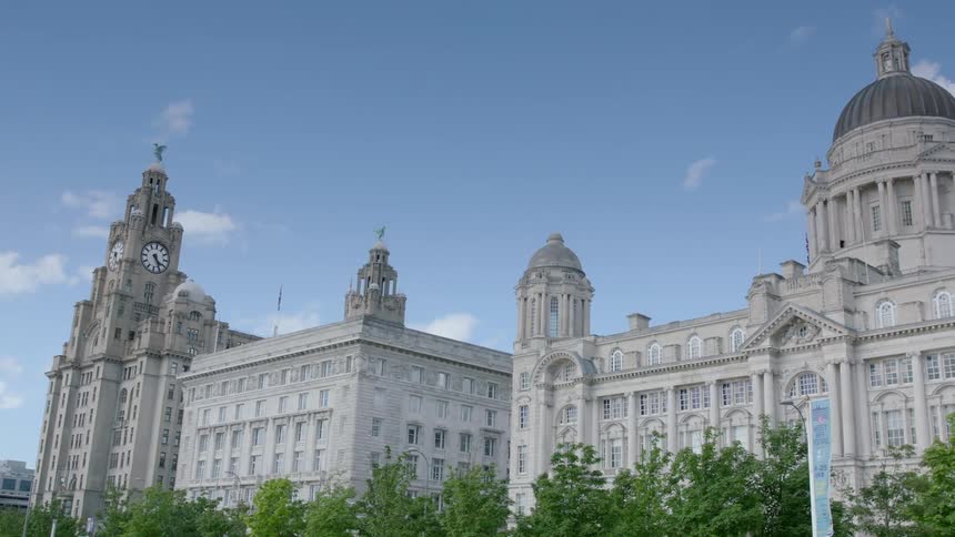 A long building has a clock tower on one side