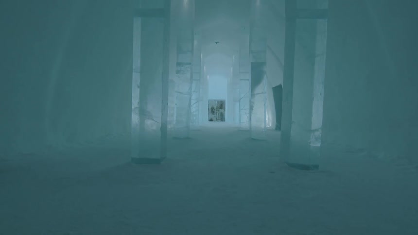 A large igloo stands with ice structures supporting the ceiling