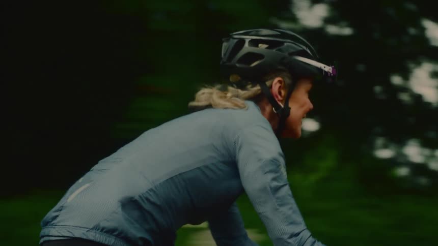 A woman pedals on her bike