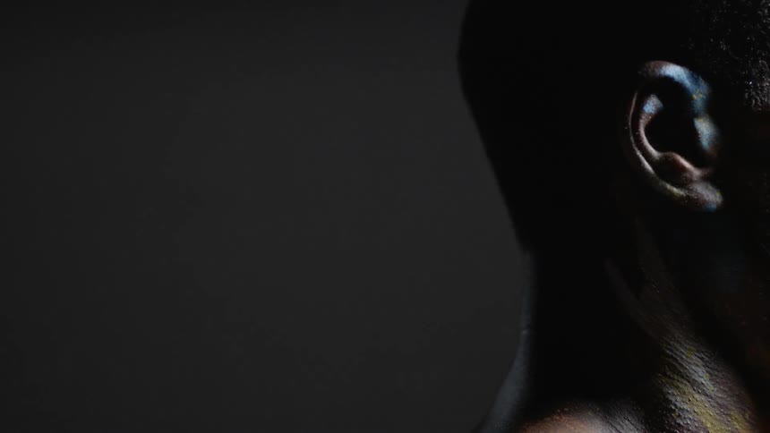 Light is cast on a man's ear