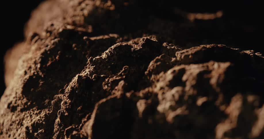 Weathered rock against a black background