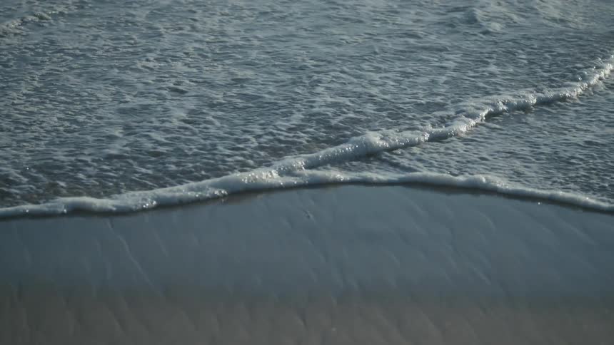 Waves crashing onto a sandy beach