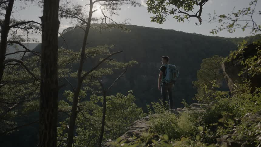 A man looks out over a cliff