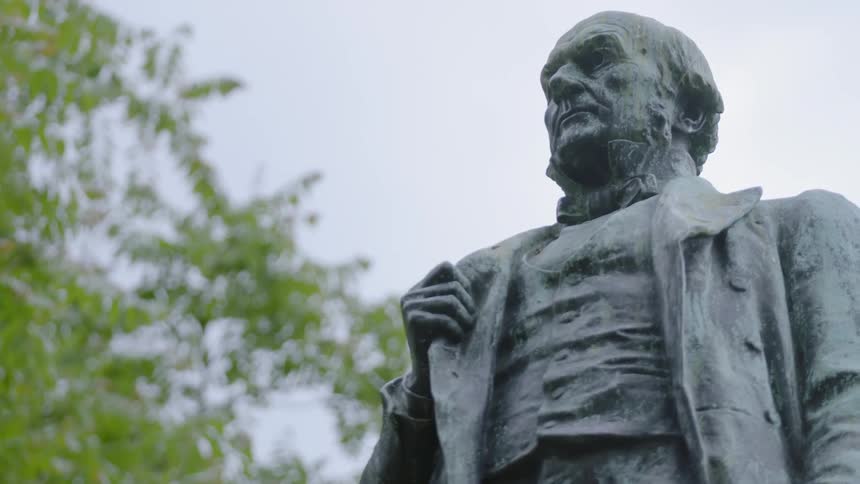 Old statue outside of a standing man