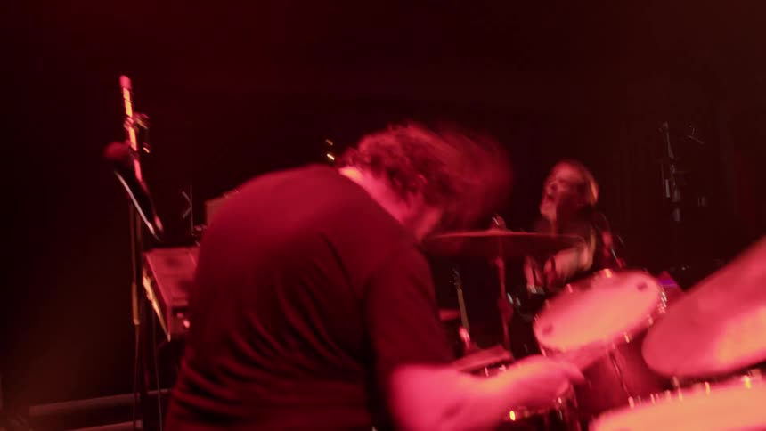 A musical band is performing a concert in front of a crowd