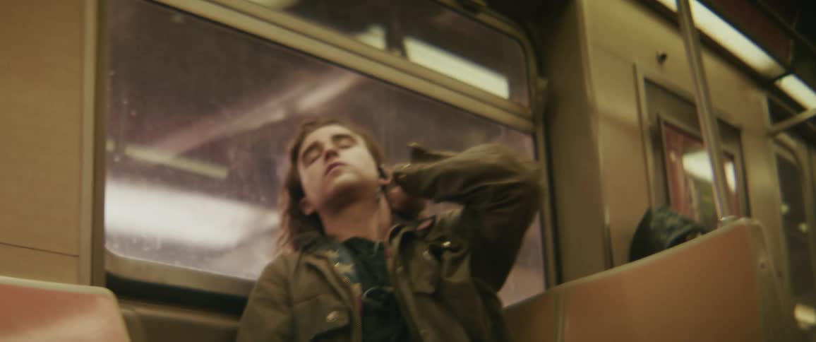 Man sitting on a moving train bench