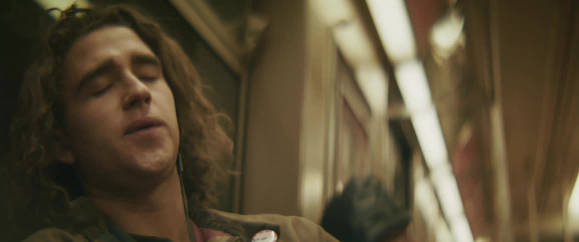 A man rests while riding on the train