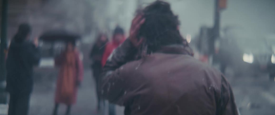 People crossing a pedestrian crossing on an urban road in the city on a snowy day