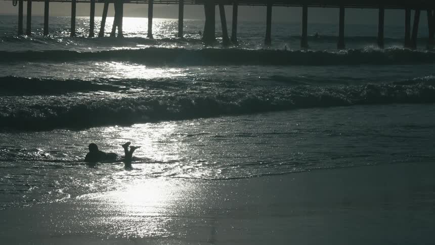 Beachgoer lays in ocean waves
