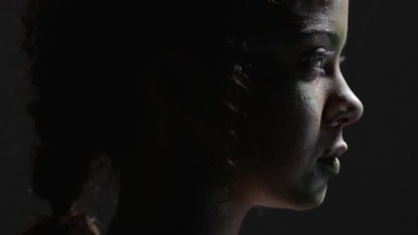 Light shines on a young girl's face