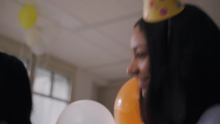 A woman is smiling and dancing