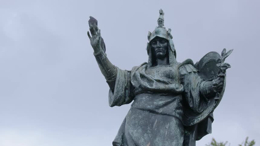 Pigeons perch atop a statue