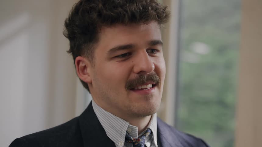 Man in suit talking smiling