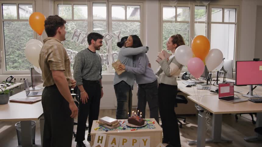 Man being surprised by his coworkers celebrating his birthday