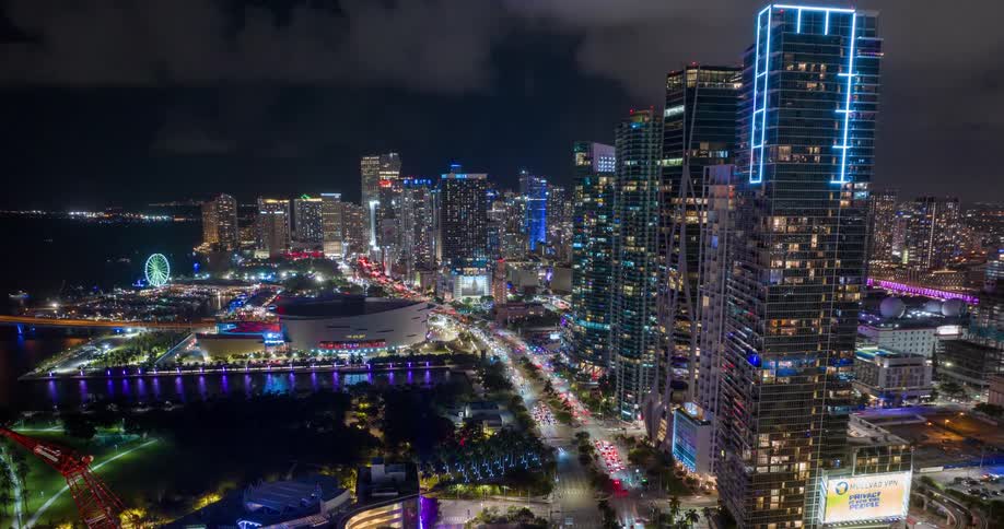 Aerial view of Miami illuminated at night and by the sea