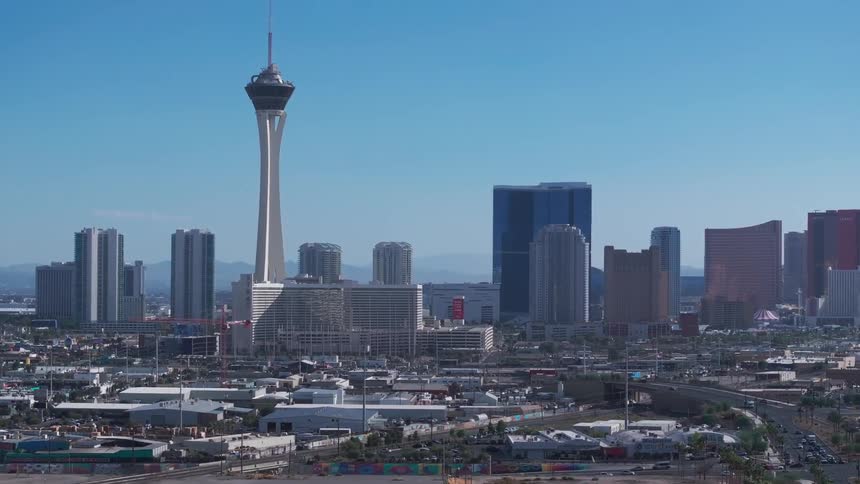 Cityscape of Las Vegas with the stratosphere tower prominently visible under a clear blue sky
