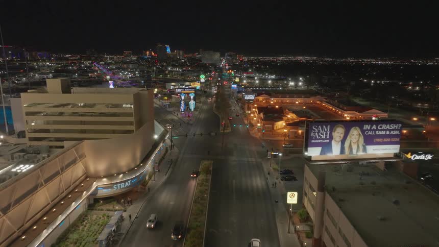 Aerial panorama of Las Vegas Boulevard with buildings and intersections illuminated at night
