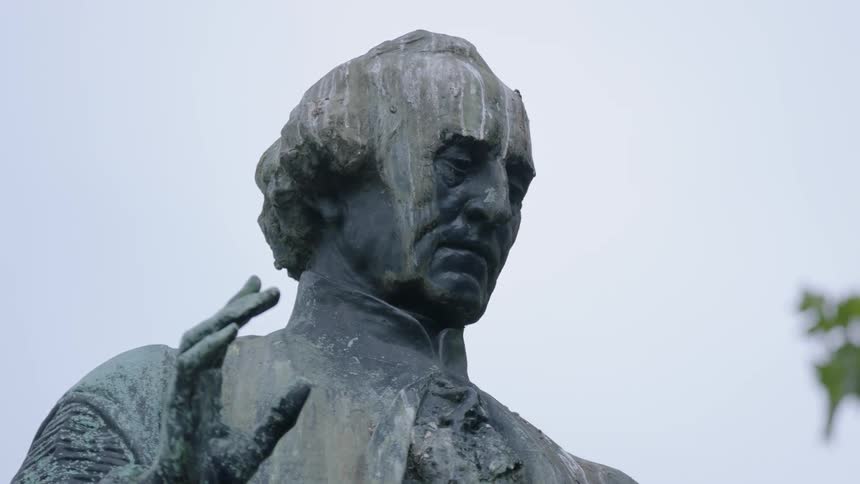 A stained statue on a cloudy day