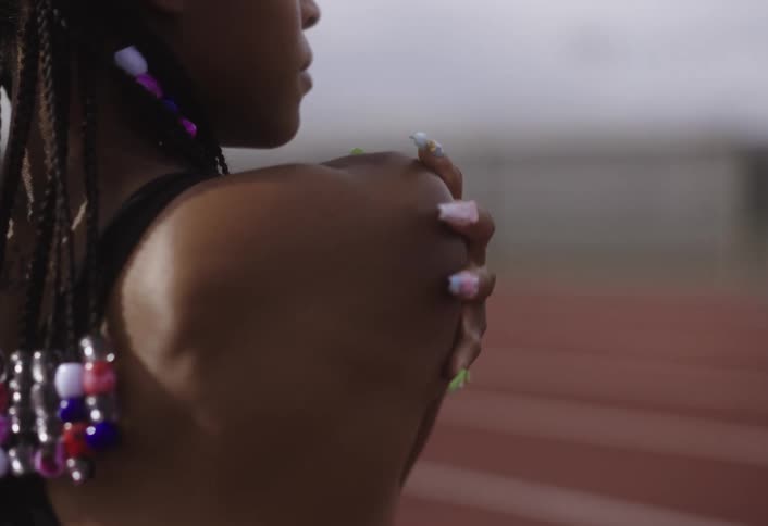 A woman is stretching on the running track
