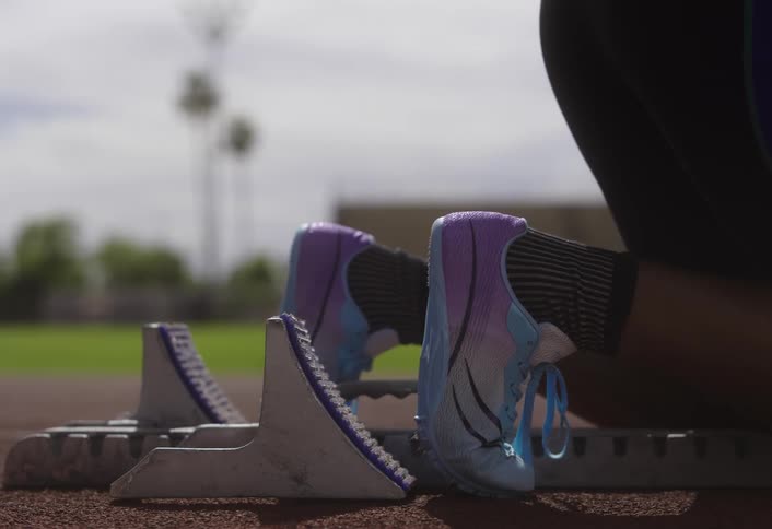 A woman takes off running on the track