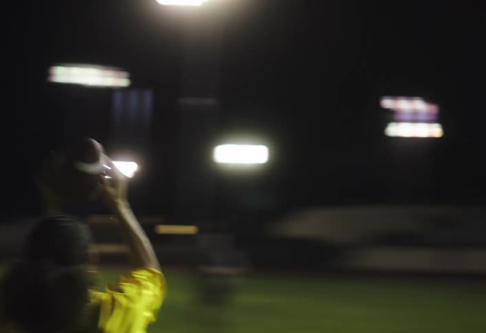 A flag football player catches the ball and runs