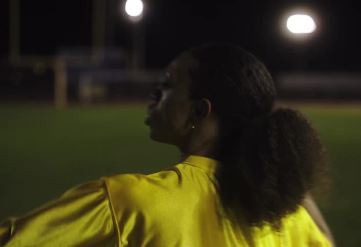 The woman throws the football during the game