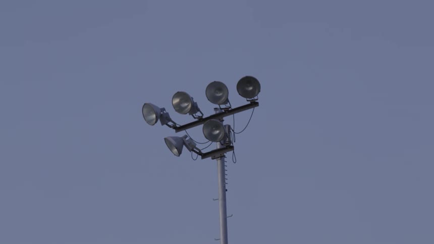 Stadium floodlights turning on