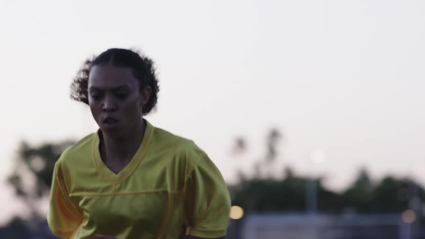 The woman runs back and forth on the field