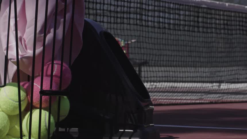 The tennis ball flies over the net