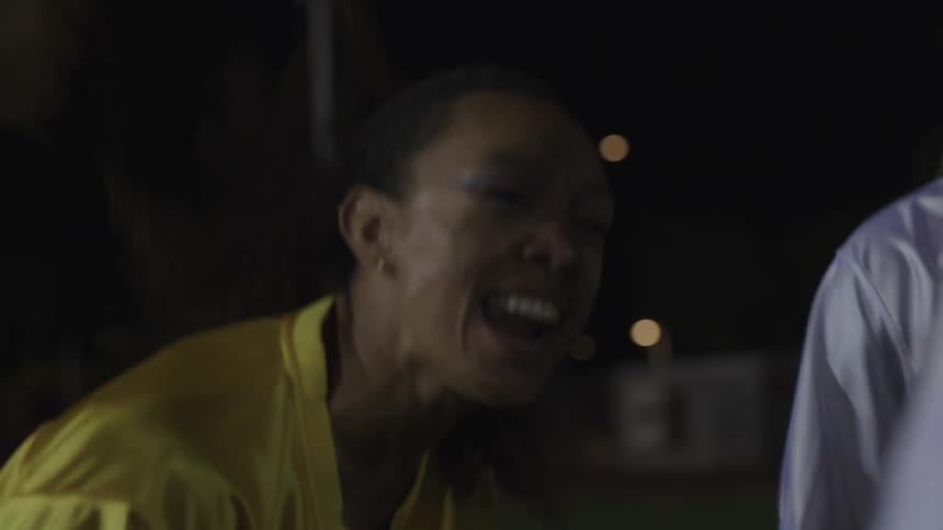 A woman is yelling during a huddle