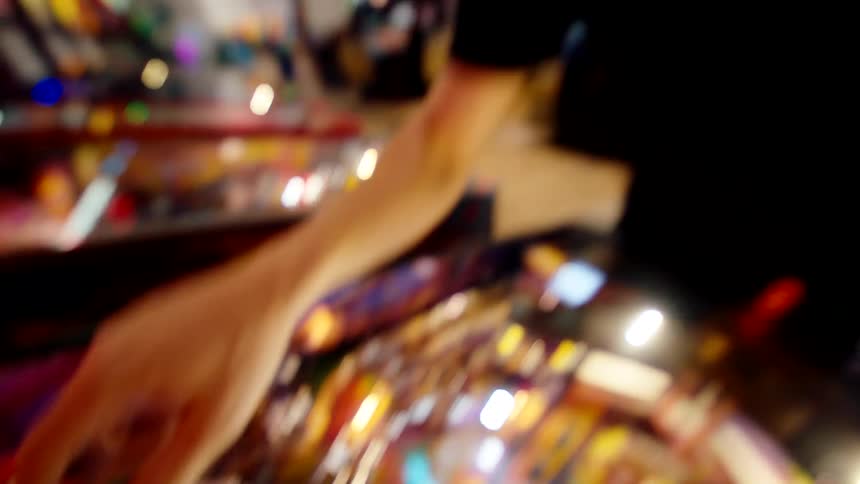 Wideeyed man at a classic arcade game machine