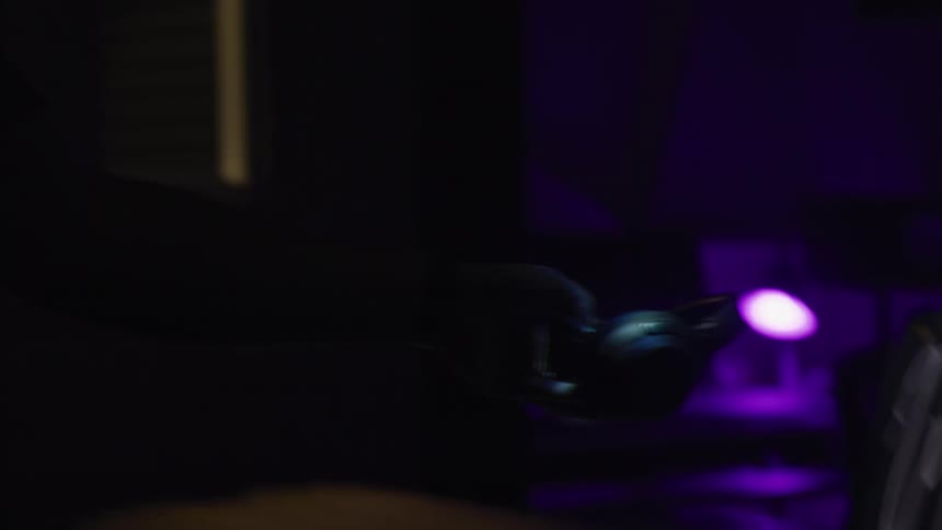 A pair of headphones is picked up