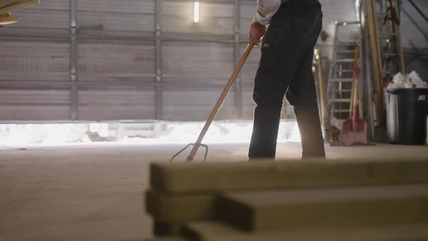 A man sweeps the floor