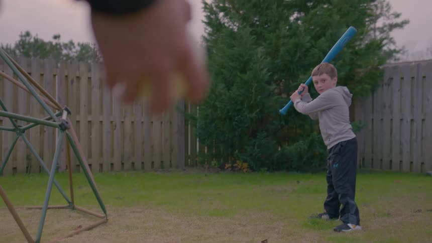 A father and son play baseball