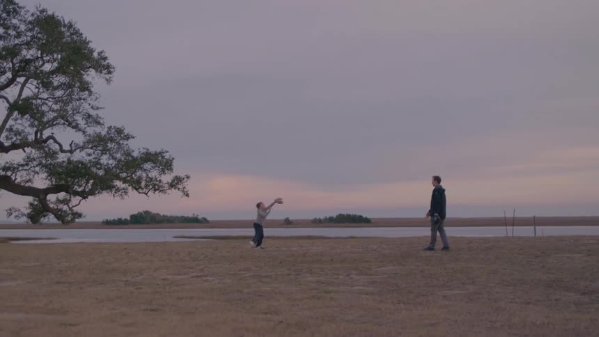 A father throws the baseball to his son