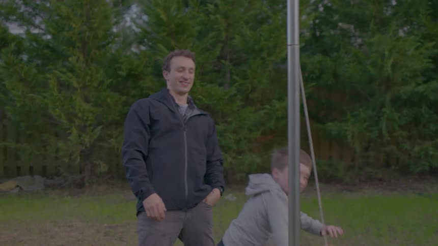 A father and son hit the tetherball
