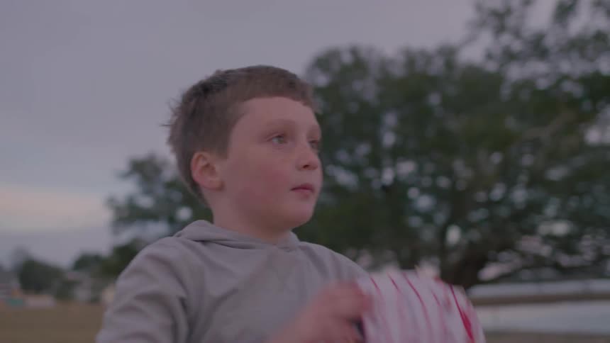 A boy throws and catches a baseball