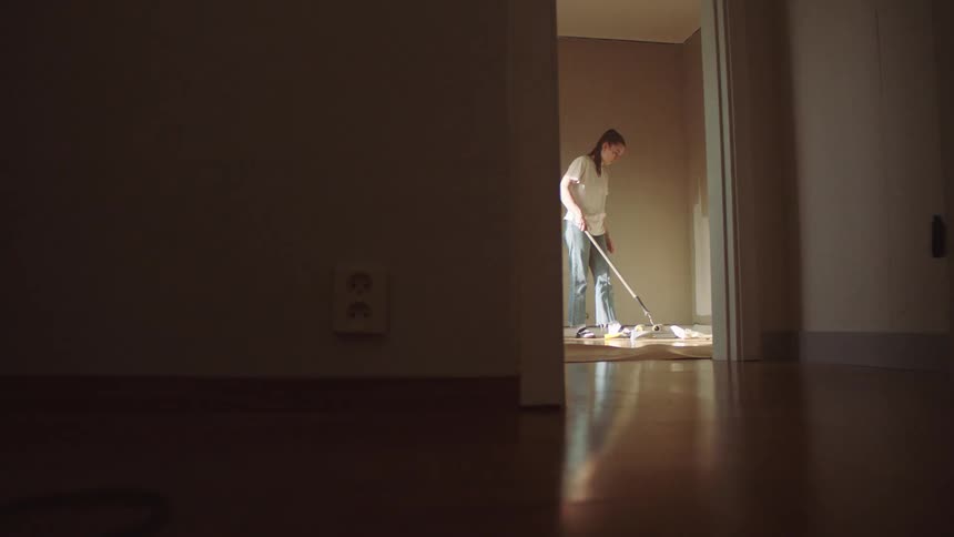 A woman paints the inside of a room